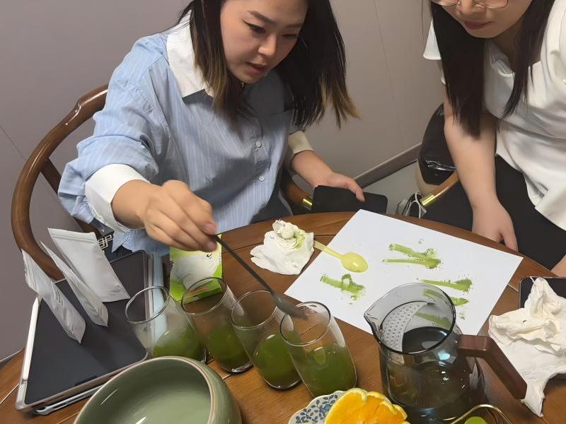 Thai Clients review matcha samples quality with Alex Yuan in the tea house room of Zhiqinghe