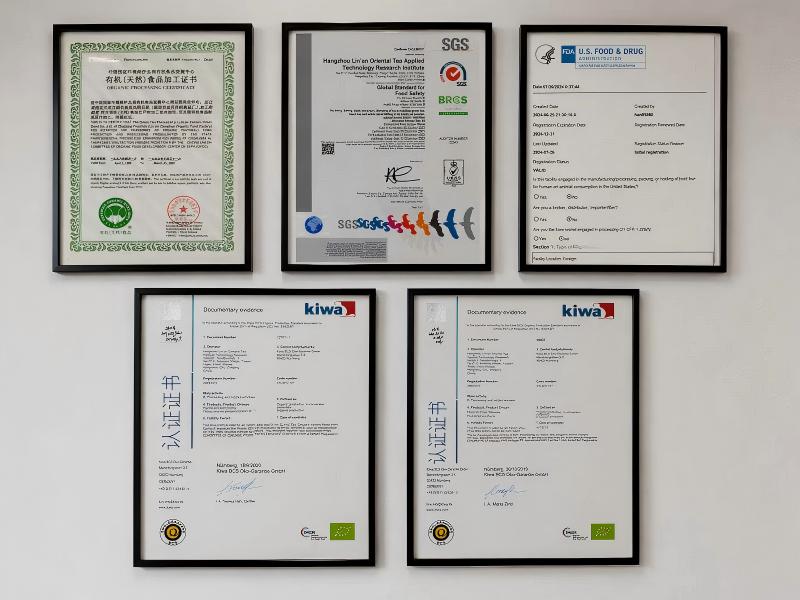 Framed USDA, EU organic, SGS, FDA, and Kiwa certification wall at Zhiqinghe