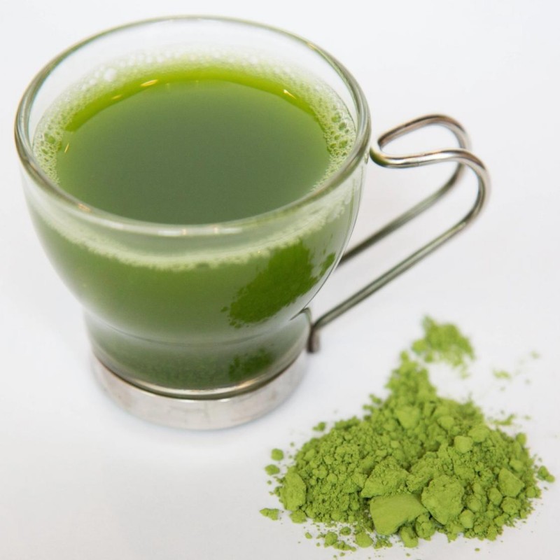 A cup of richly colored matcha drink