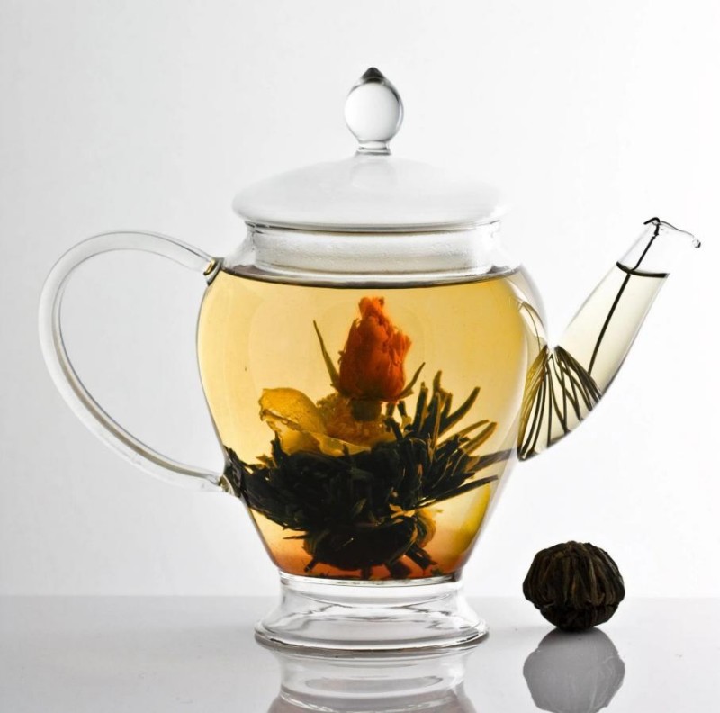 Blooming tea slowly unfolds in hot water